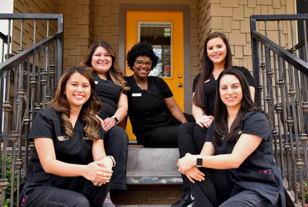Group photo of a dental office showcasing the team members and practice culture