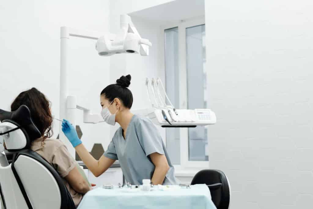 Dentist cleaning patient's teeth