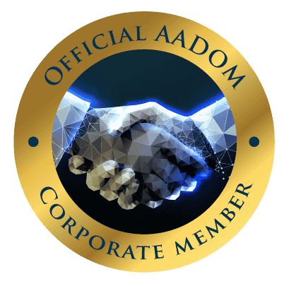 Badge reads "Official AADOM Corporate Member" and shows handshake.