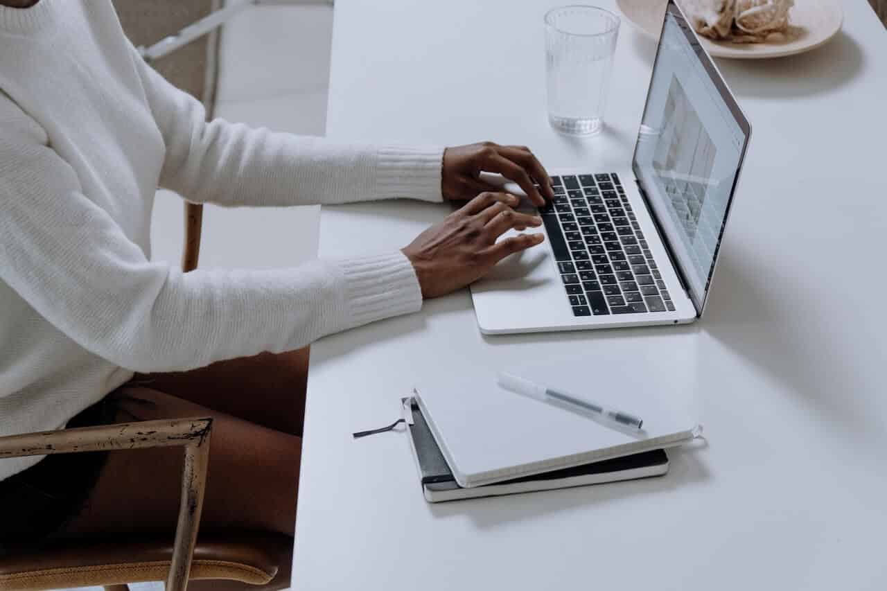 Woman's hands typing on laptop