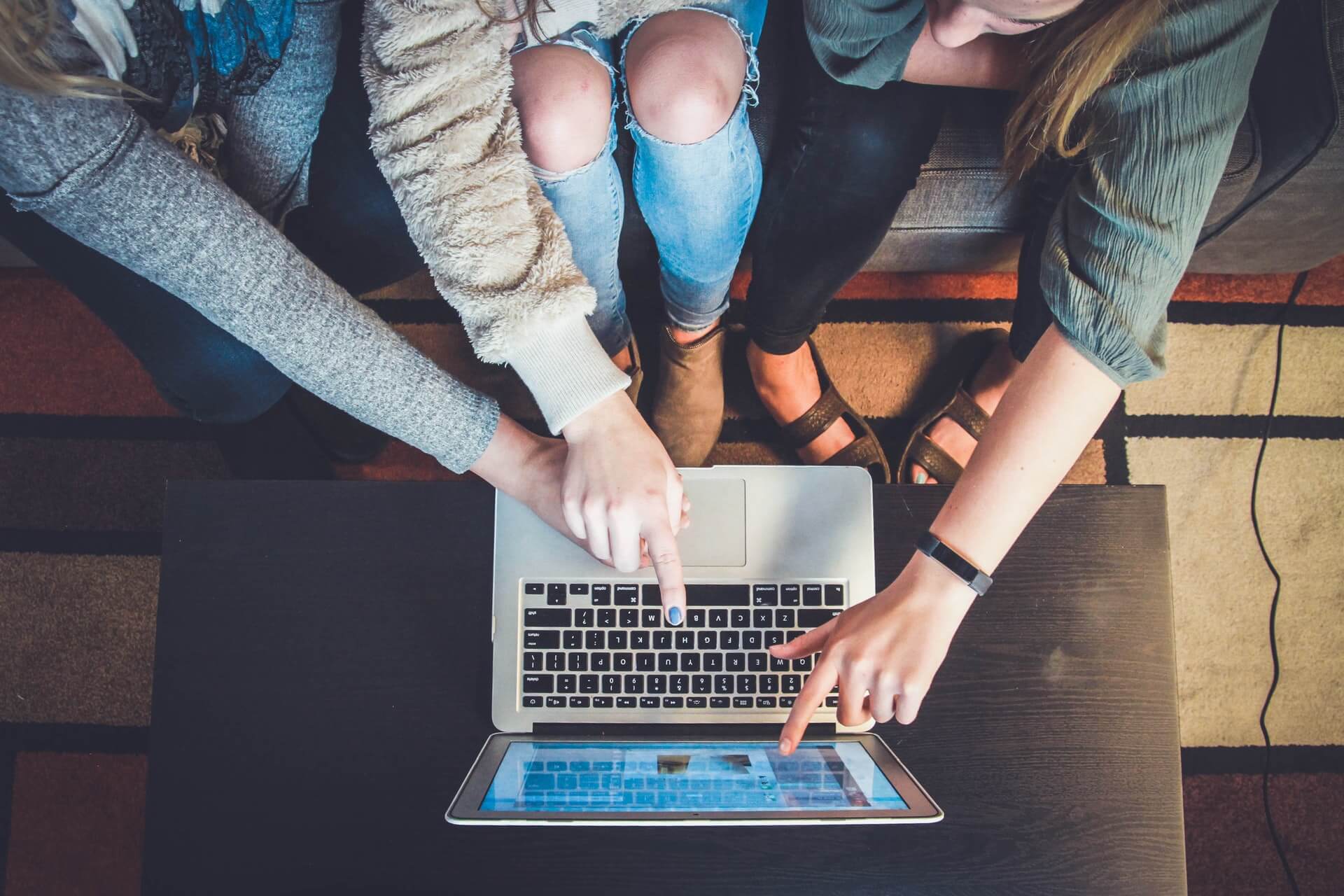 Hands pointing at laptop