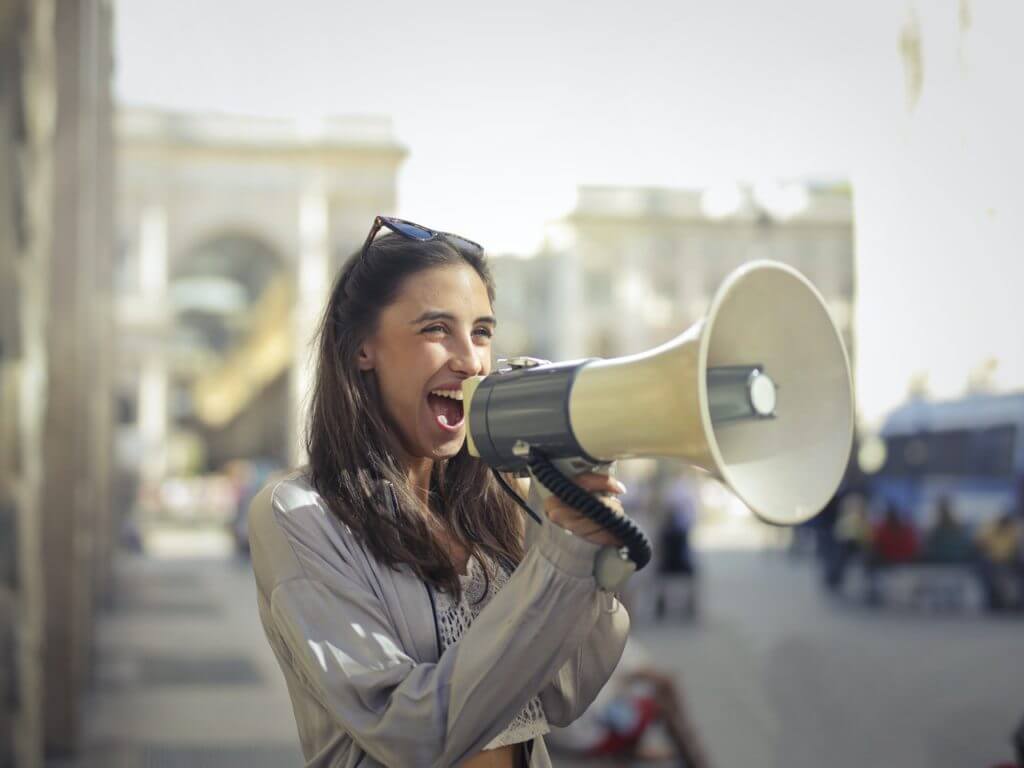 Woman shouting into megaphone