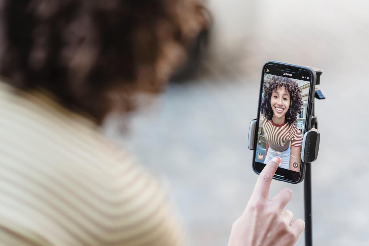 woman recording video on iphone