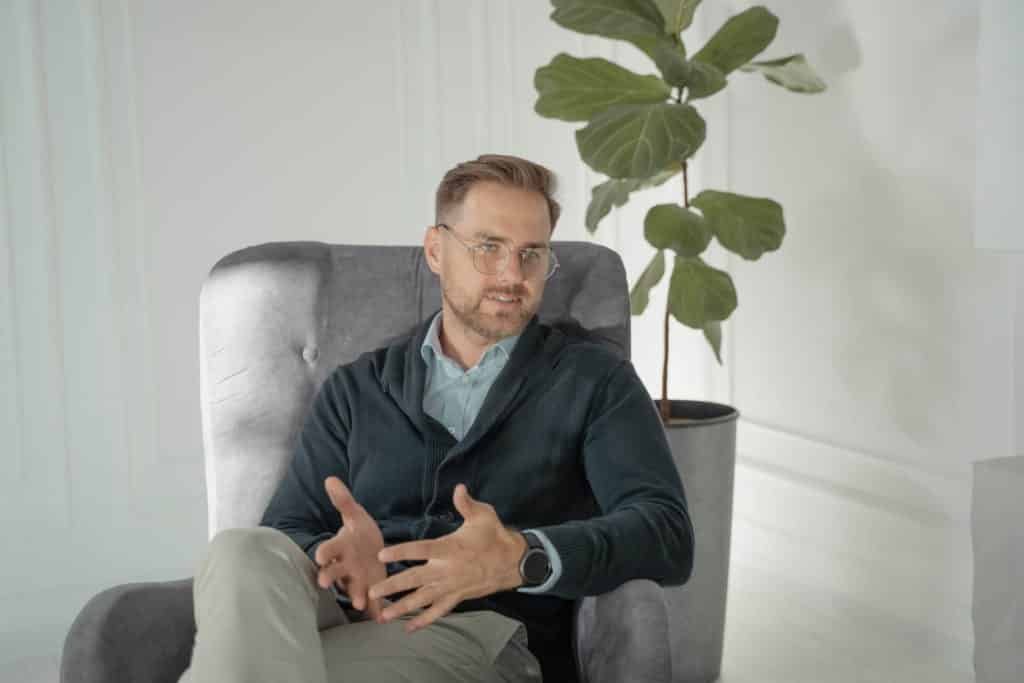 Man sitting in chair, gesturing