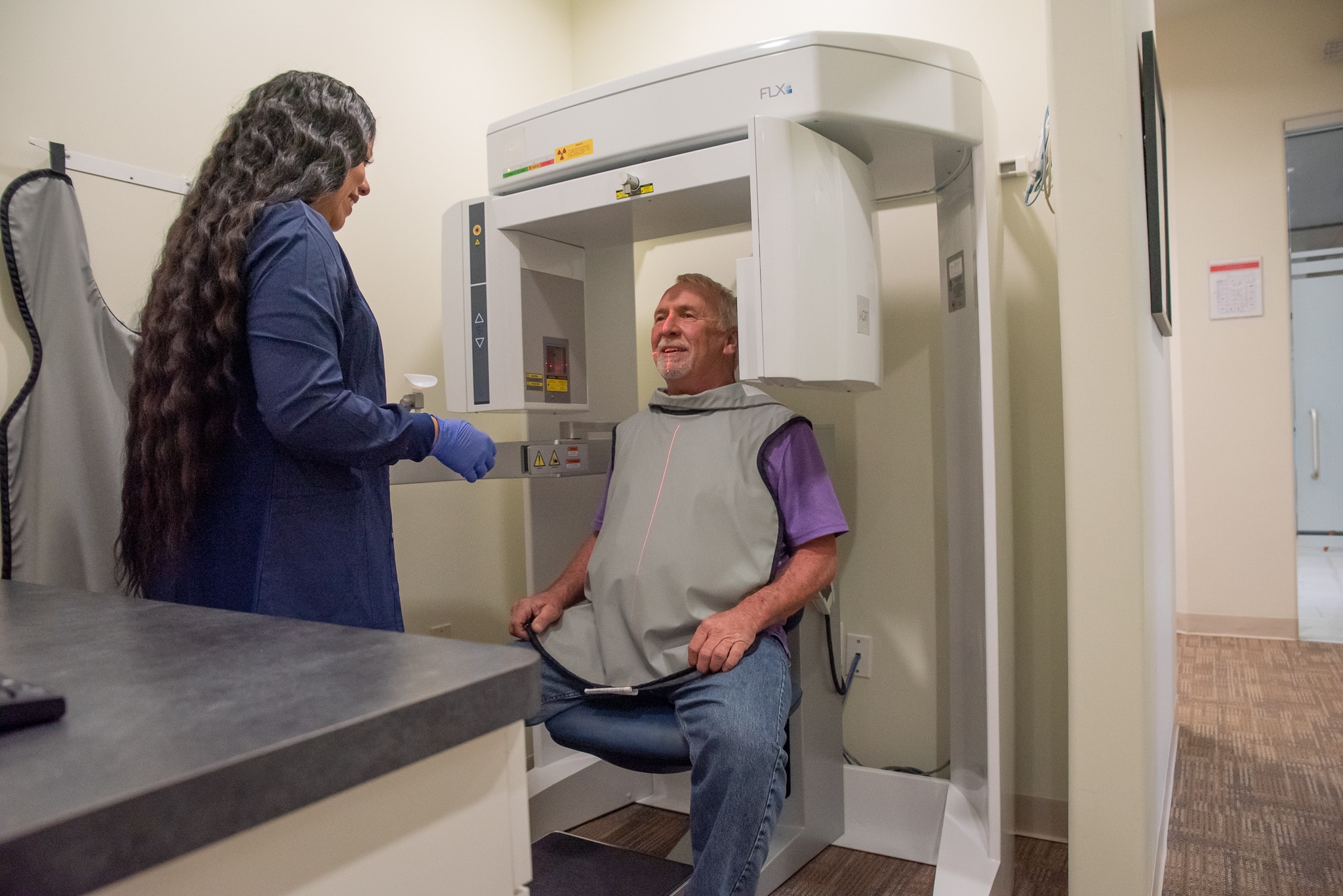 Hygienist performing X-Ray on dental patient