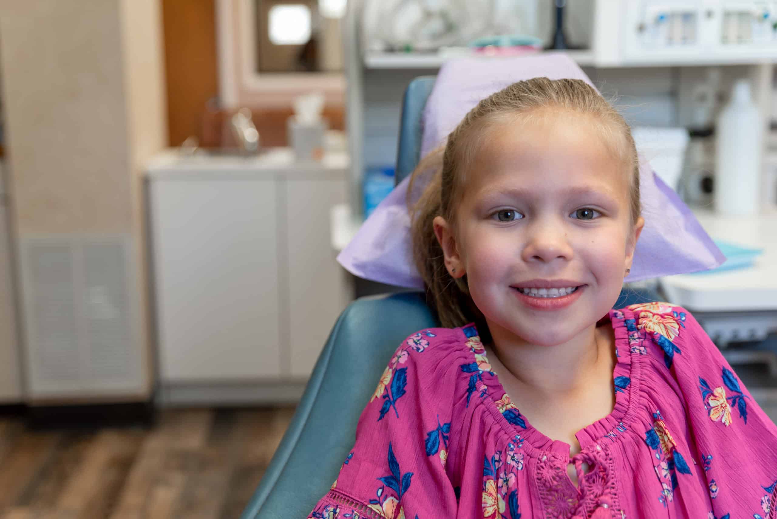 Child smiling in dental chair