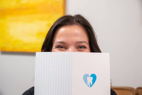 dental marketing employee peeking over card