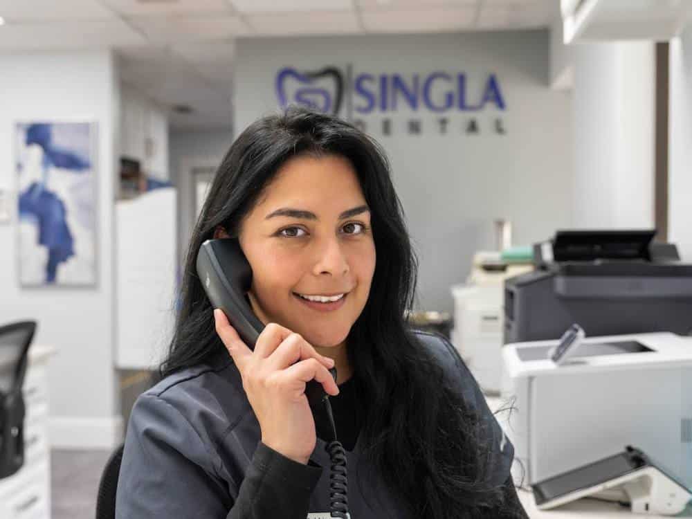 A dental office receptionist answering a call tracked by CallRail