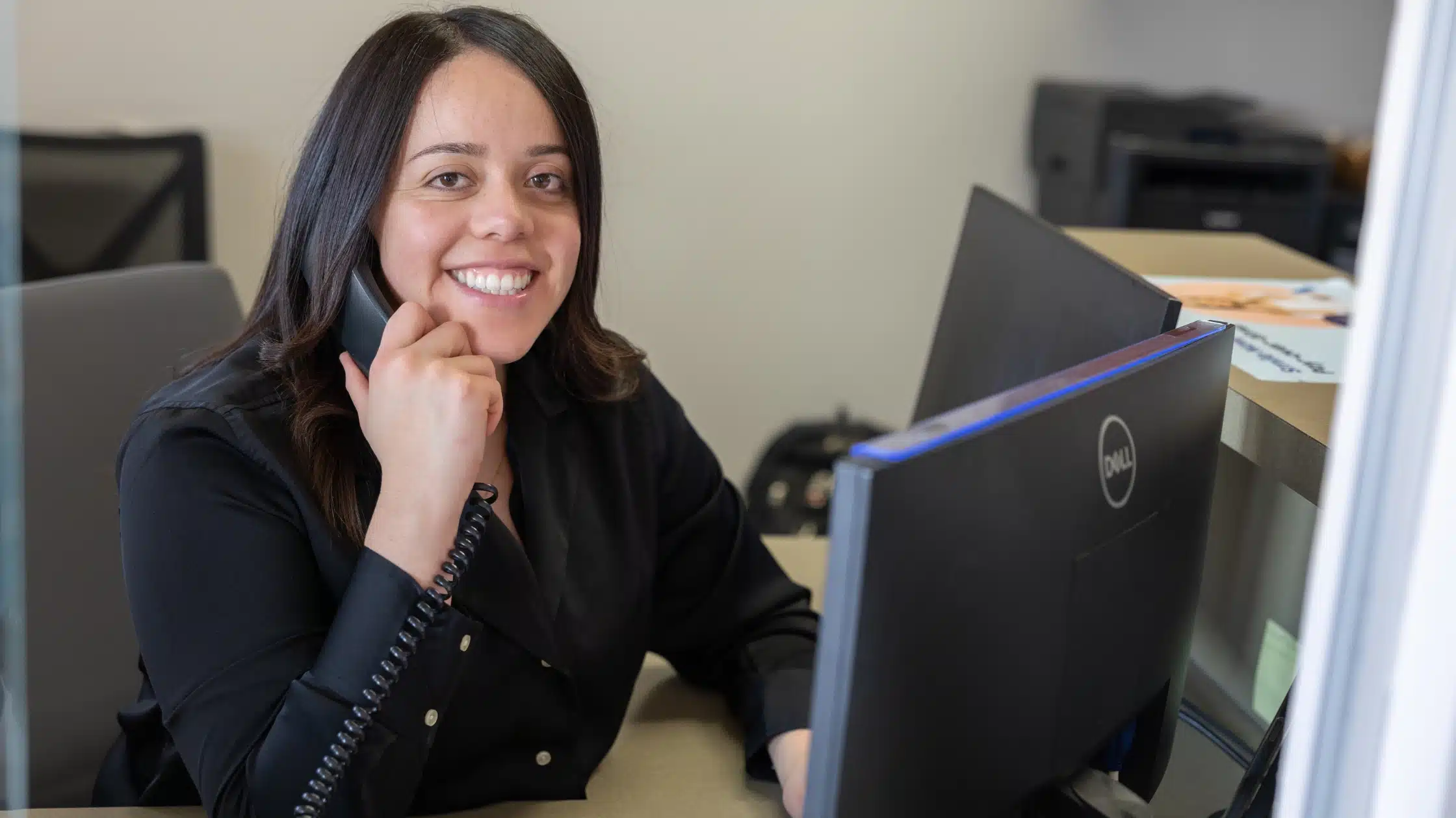 Dental office front desk receptionist answering a patient call
